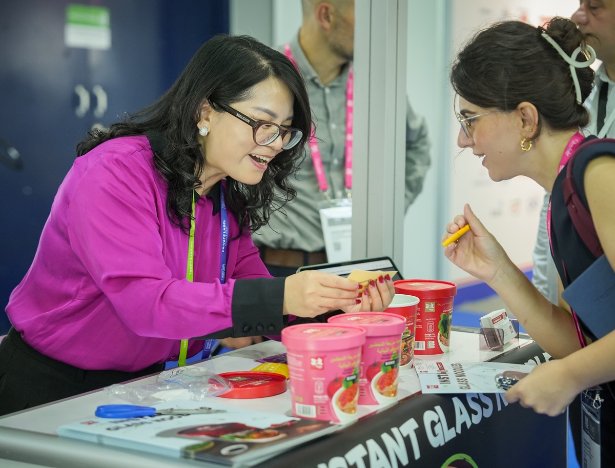 Exhibitor presenting private label food products to a buyer at Private Label Middle East