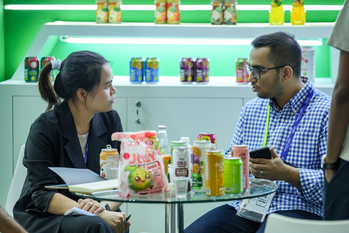 Buyer and supplier discussing beverage samples at Private Label Middle East