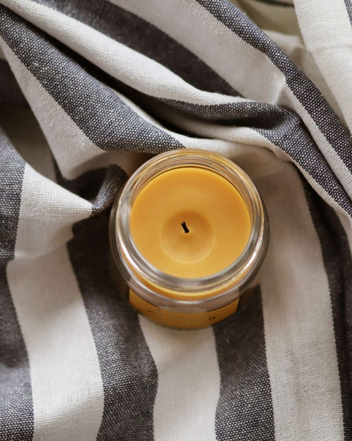 Image of a single, lit candle with a calm, steady flame, creating a warm and cozy ambiance.