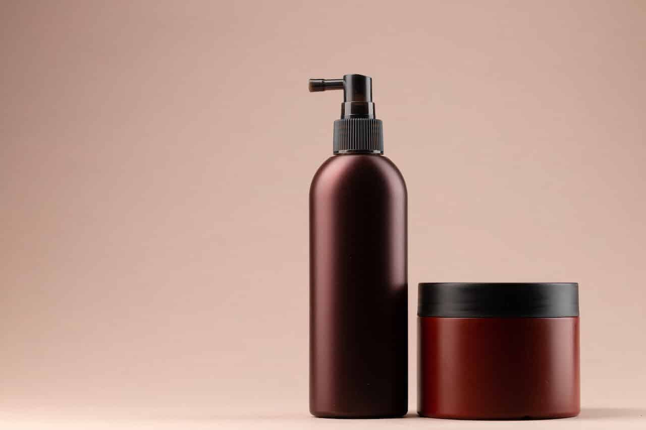 Brown plain cosmetic package on beige background, copy space