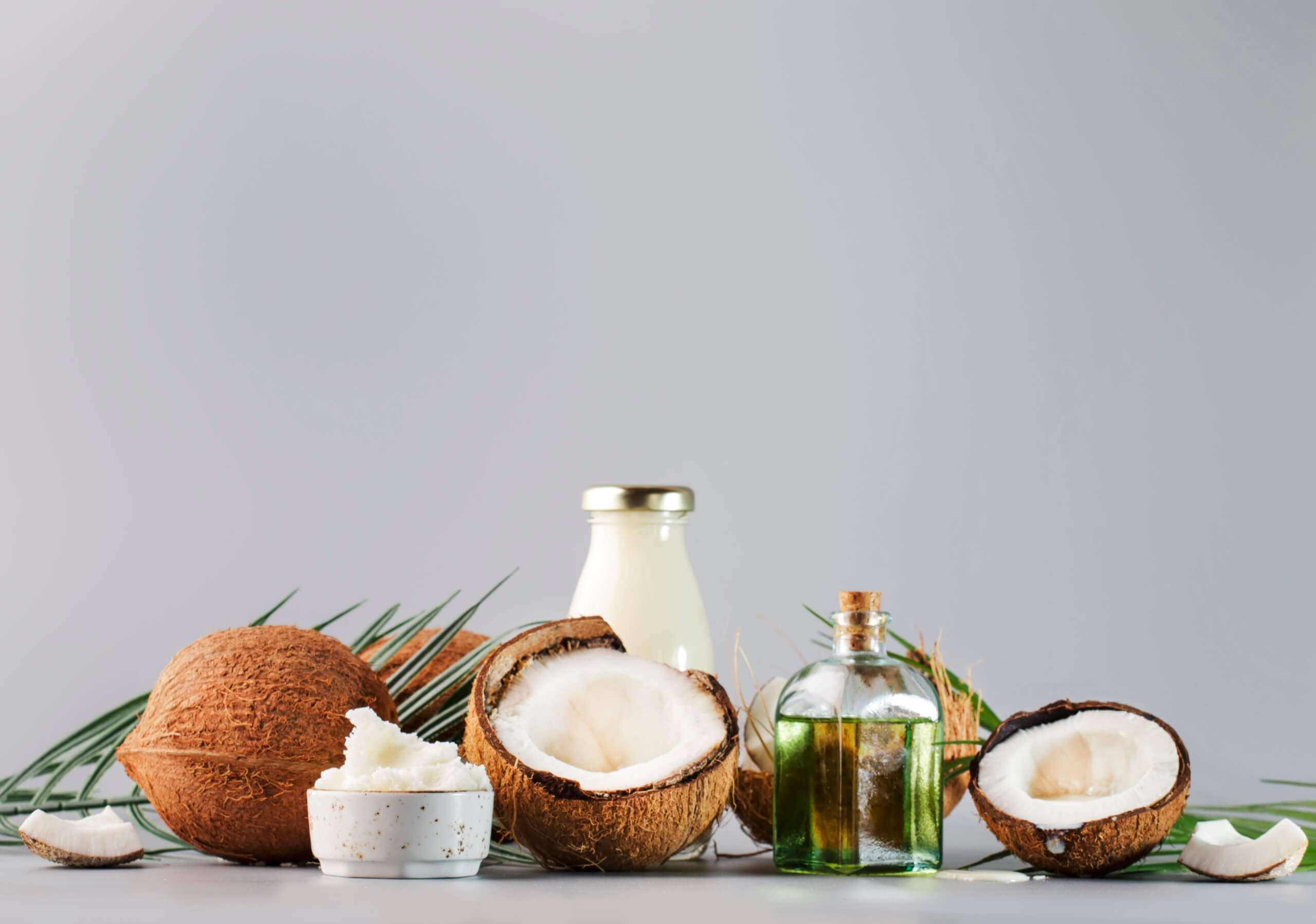 MCT Coconut butter or coconut oil. Organic healthy food, beauty and SPA concept. Gray background. Copy space