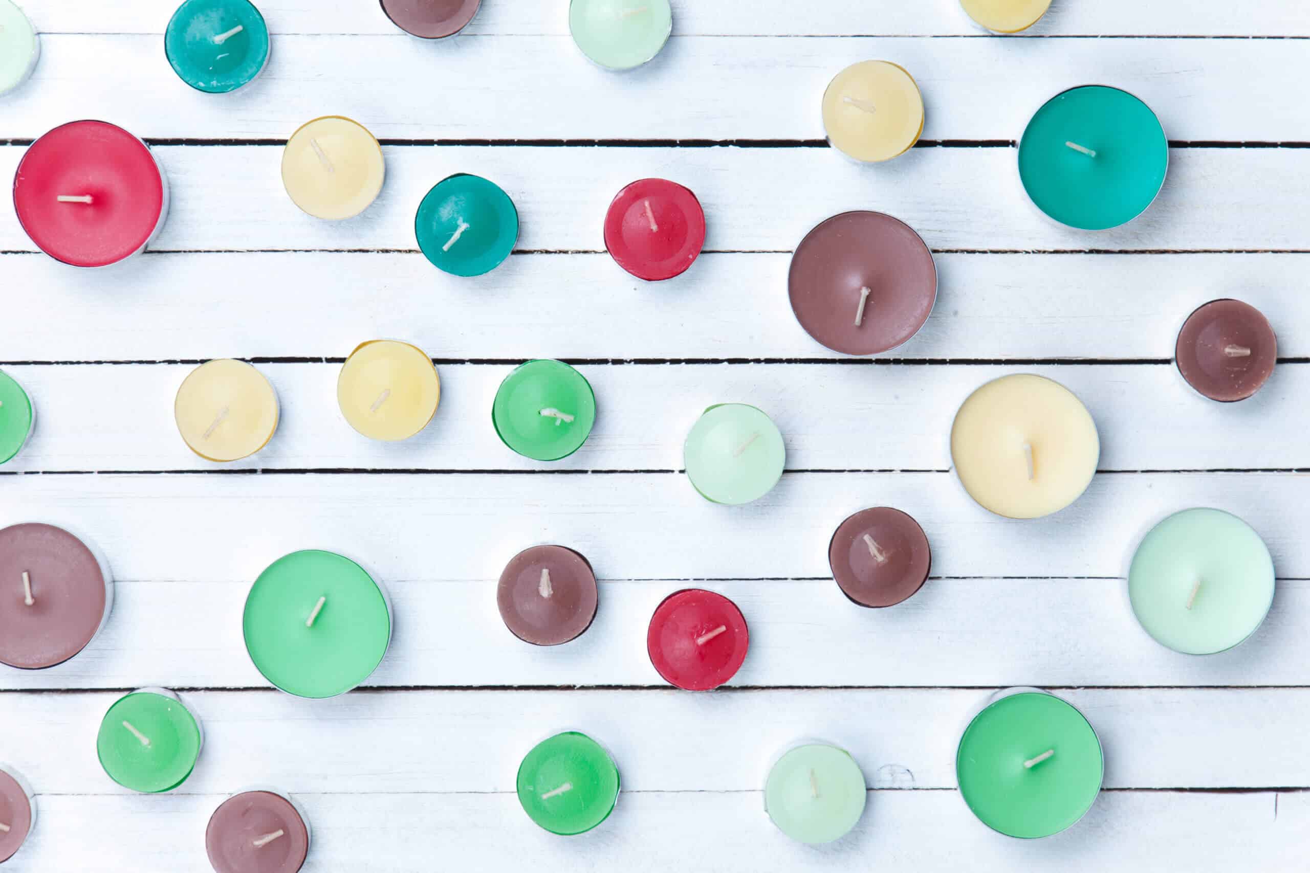 Color candles on white wooden background