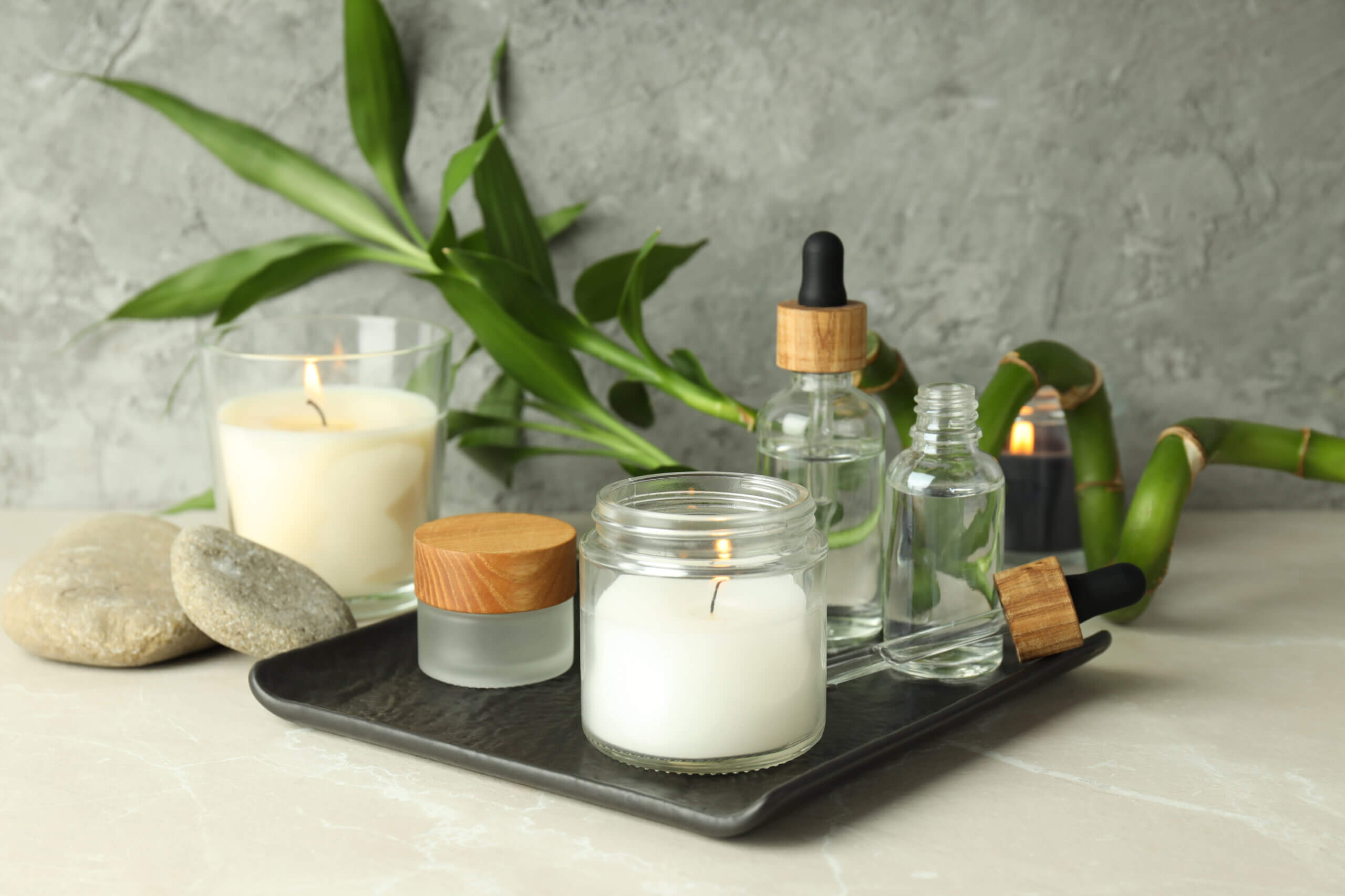 Concept of relaxation with aroma candles on light textured table
