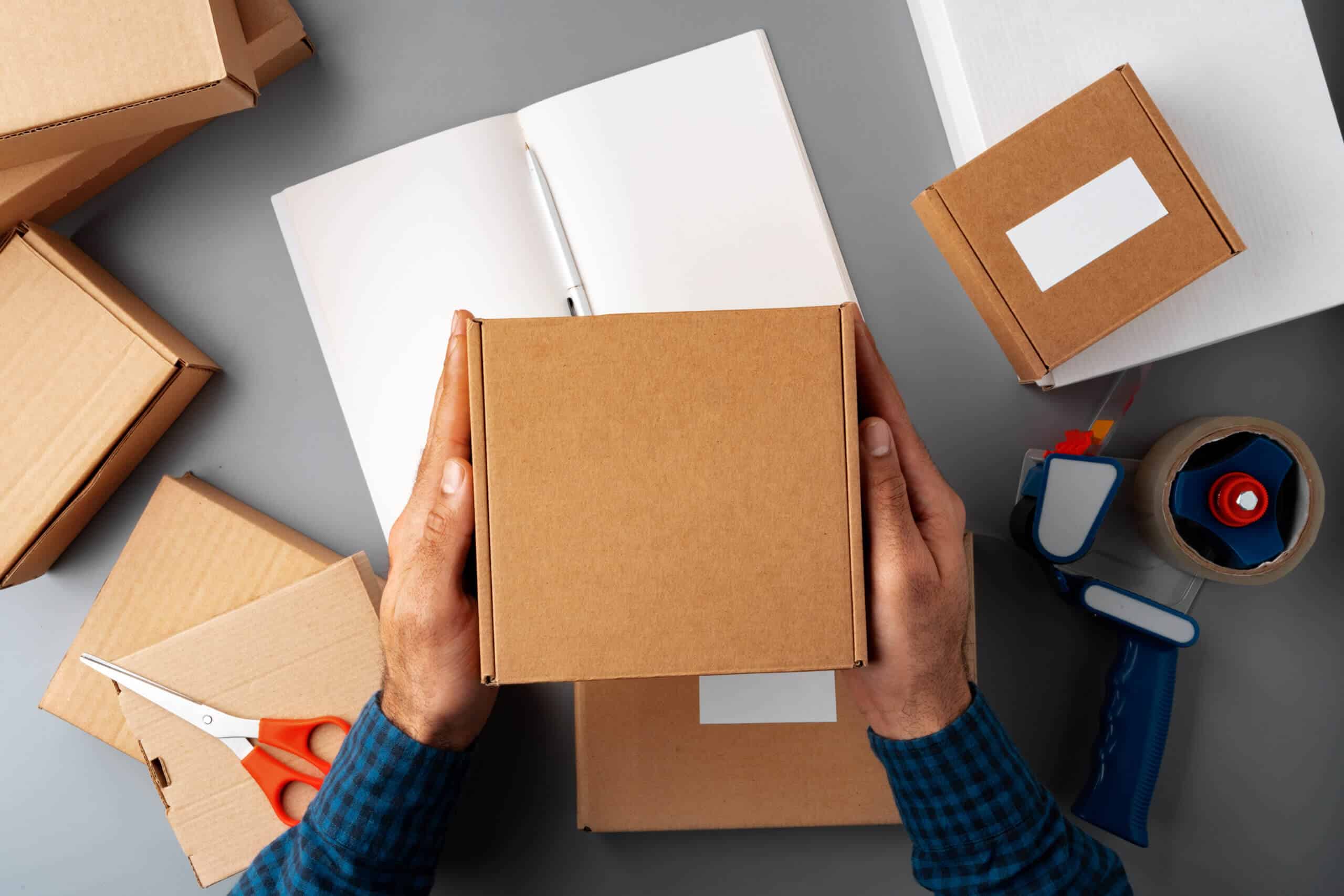 Above table top view of warehouse preparing post courier delivery package box