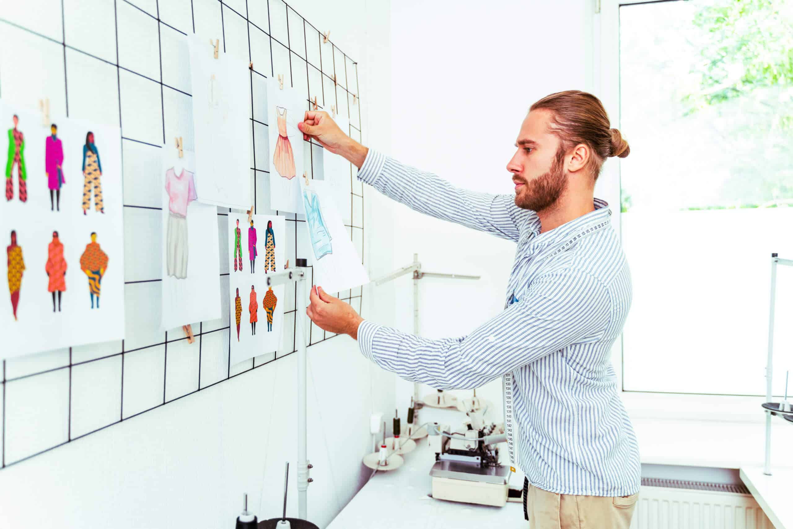 Clothing stylist creating a new design for a dress - Fashion designer working on a clothing brand in a textile factory for brand visibility 