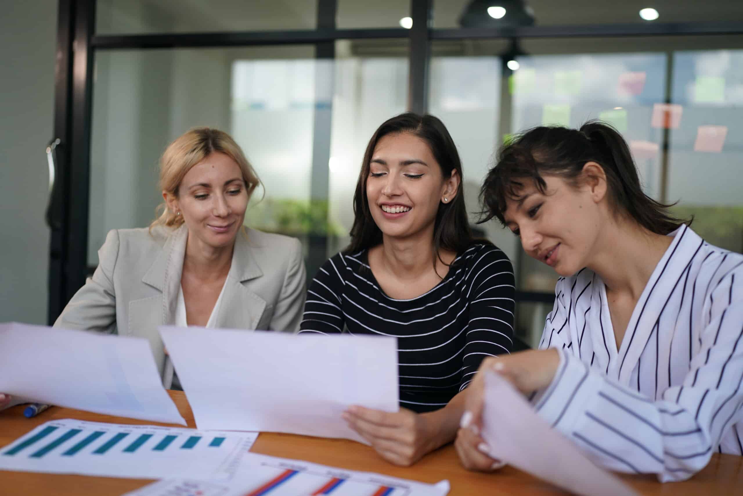 email marketing specialists using computer to send newsletters to clients 