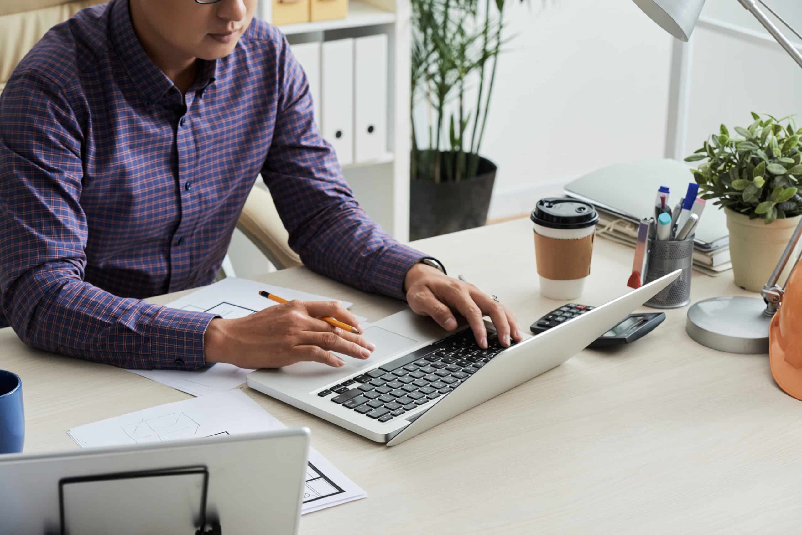 Cropped image engineer using laptop to communicate with client