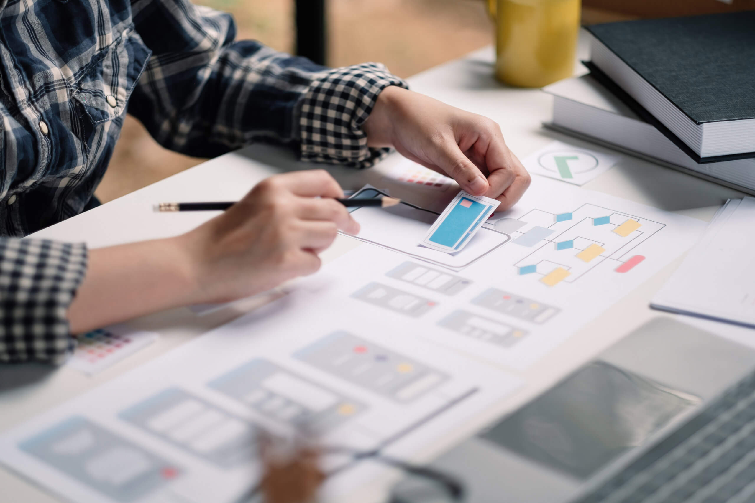 Close up App developer Ux Ui designing with paper model on mobile application prepare with certification for private label business