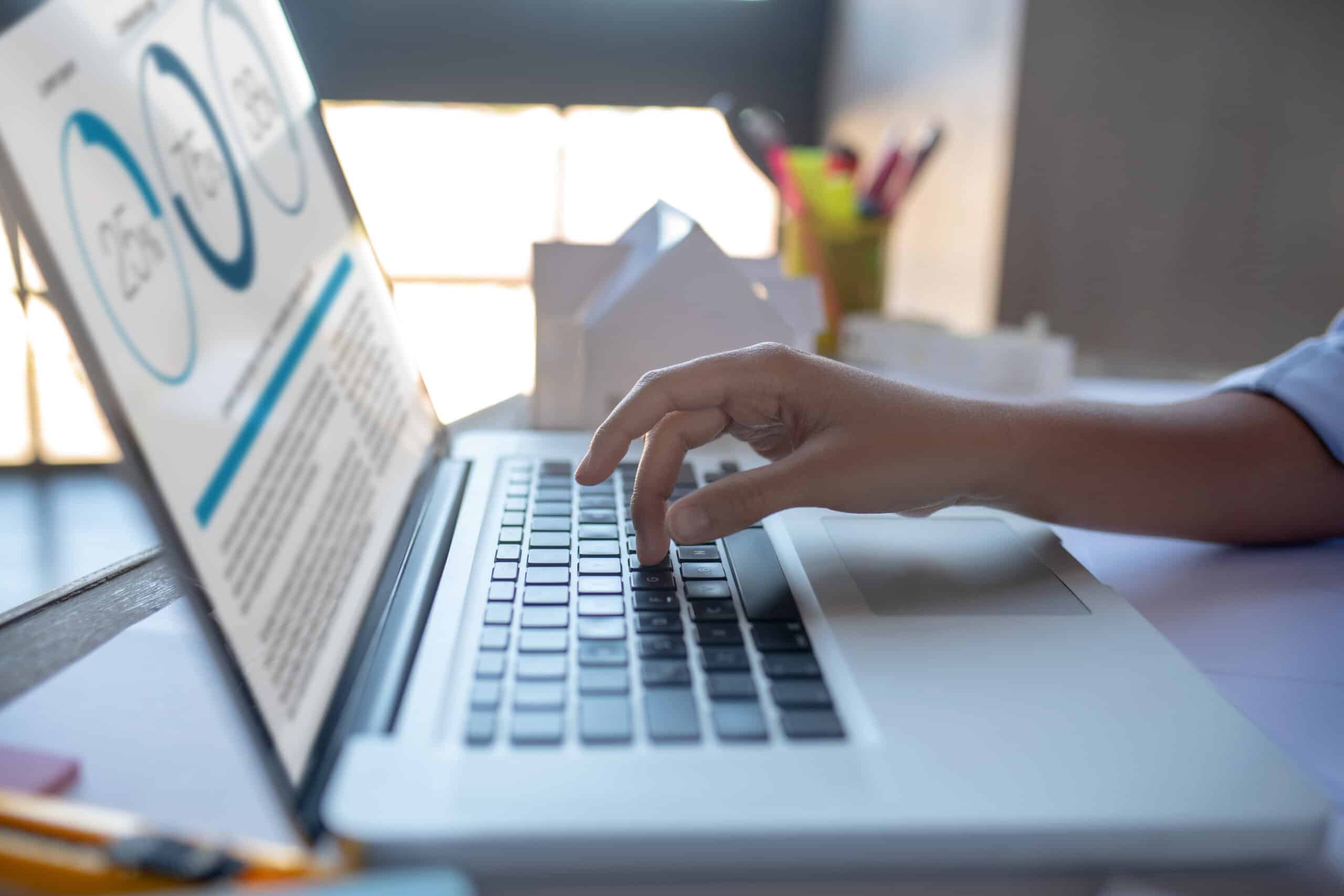 Typing e-mail. Close up of businesswoman typing e-mail for investor on laptop