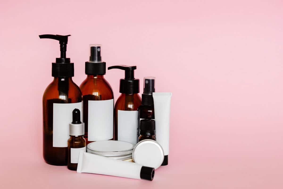 Small containers showcasing a variety of skincare cosmetic samples, such as creams and serums, arranged neatly, offering potential customers a sneak peek into the product line.