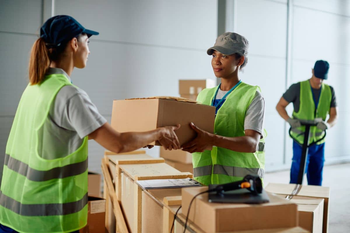 Woman holding multiple packages, ready for delivery.
