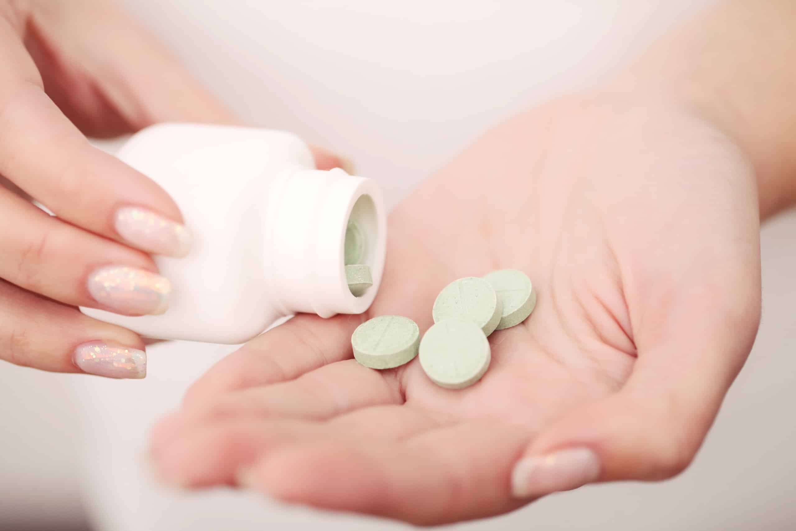 Vitamins And Supplements. Closeup Of Woman Hands Holding Variety Of Colorful Vitamin Pills. Close-up Handful Of Medication, Medicine Tablets, Capsules. Healthy Diet Nutrition Concept. High Resolution