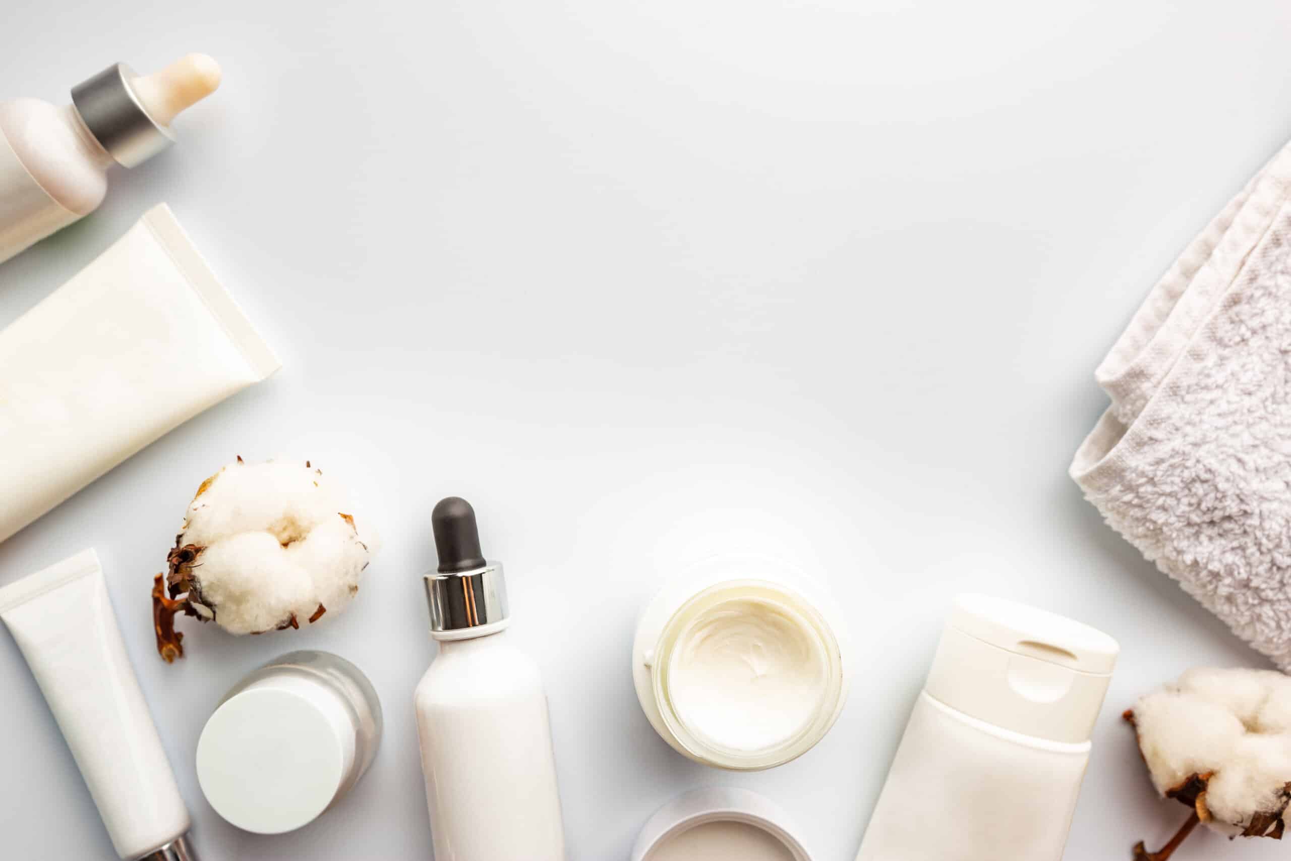 Flat lay composition with skin care products on white background