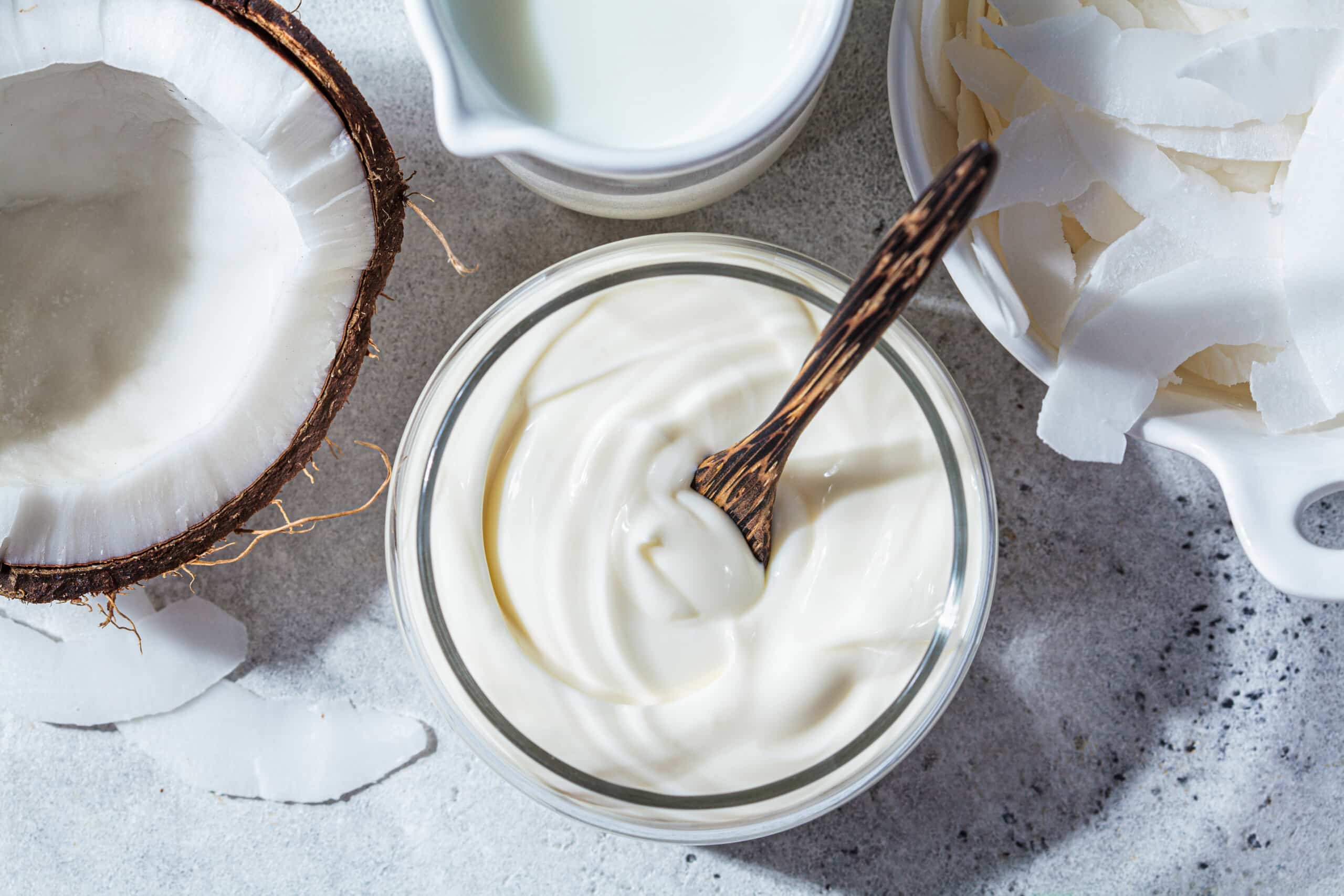 Vegan probiotic coconut products - milk, yogurt and chips, white background.
