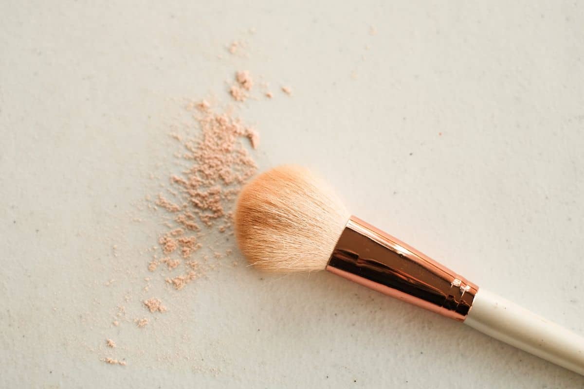 Nahaufnahme eines professionellen Make-up-Pinsels vor einem sauberen, neutralen Hintergrund, der die feinen, weichen Borsten hervorhebt, die für das präzise Auftragen von Kosmetika entwickelt wurden.