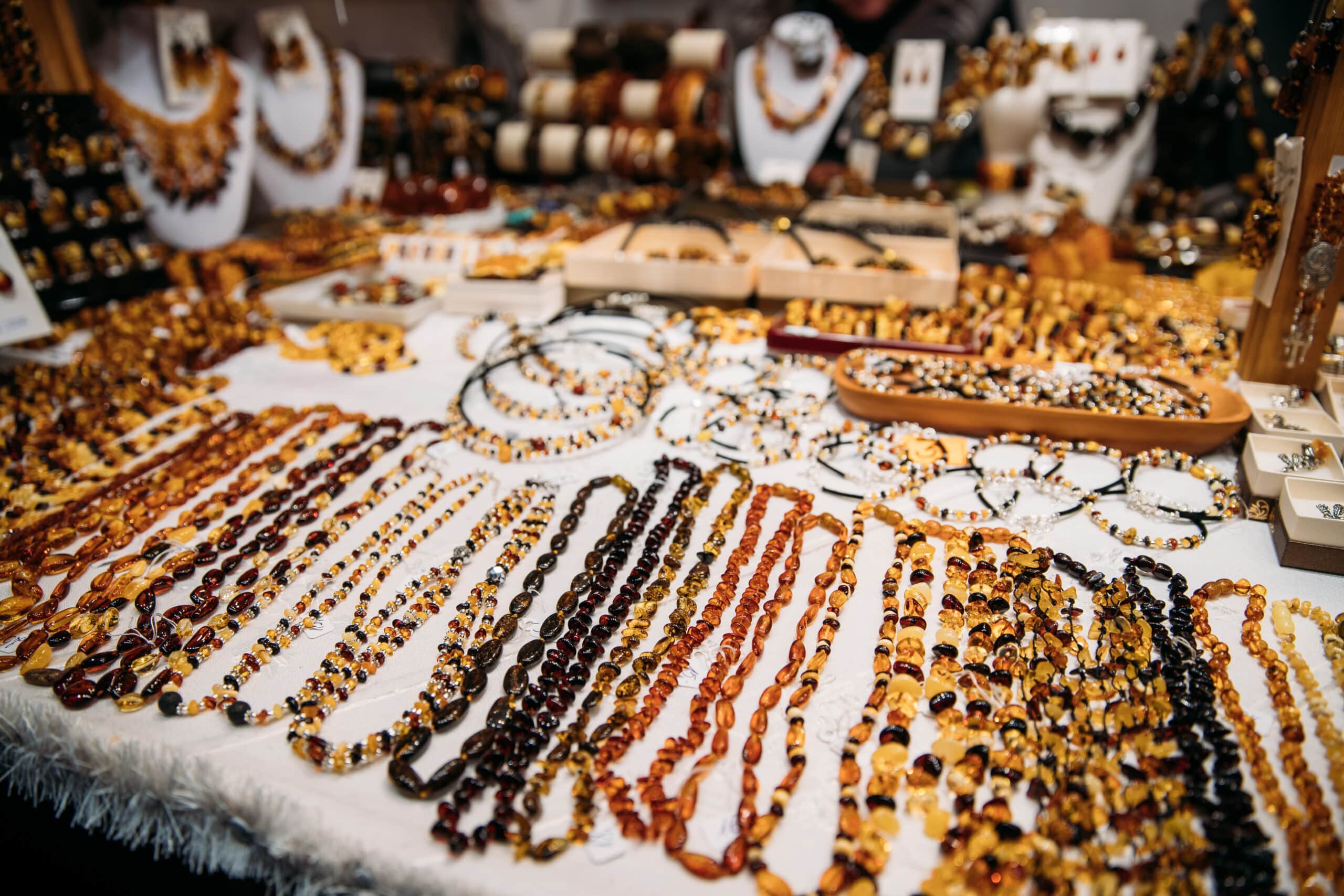 Variety Of Beads Made Of Amber. Jewellery Made Of Amber. Traditional Souvenirs At European Market. Souvenir From Baltic Countries, Europe.
