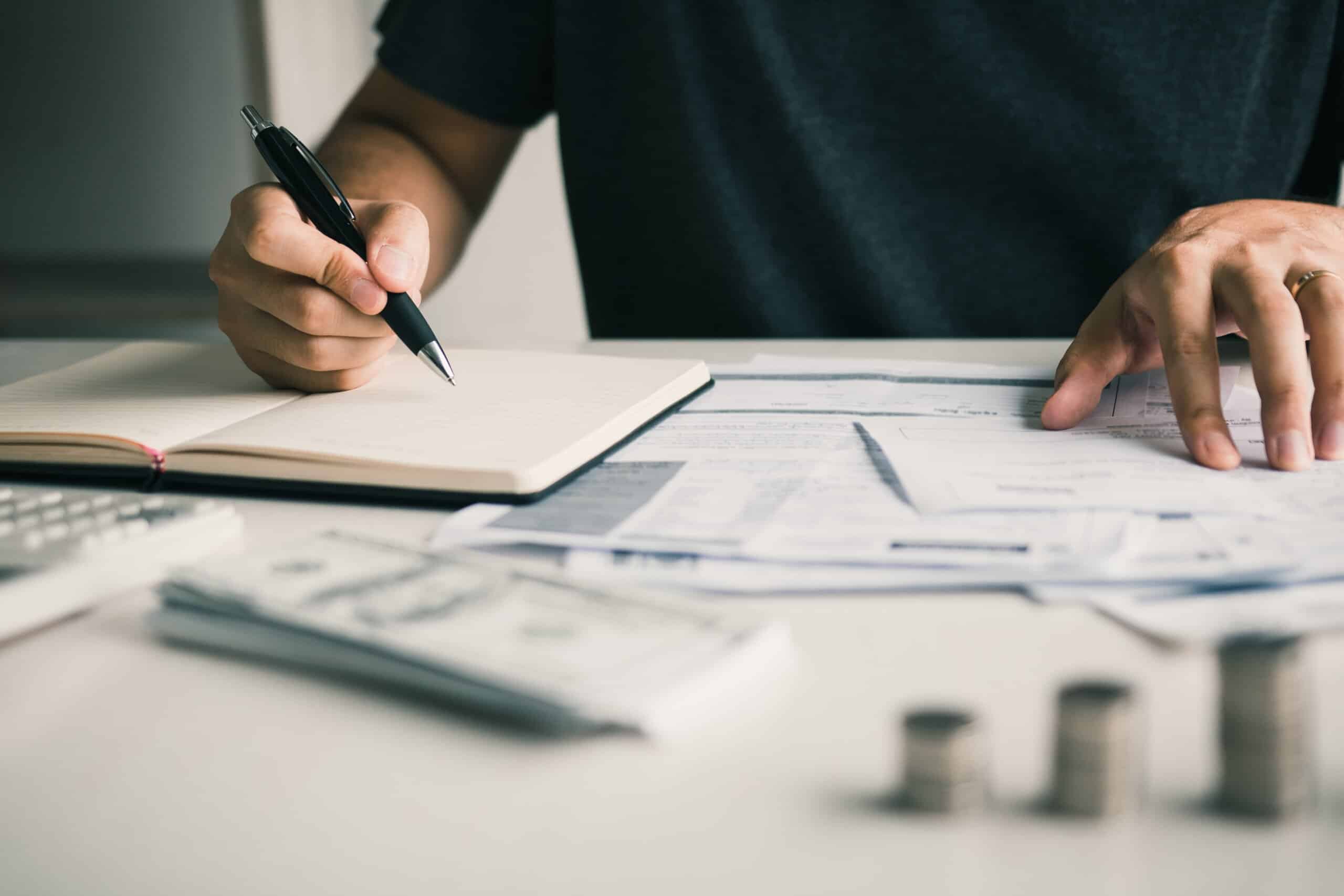 Man use calculators and documents that calculate expenses in the home office.