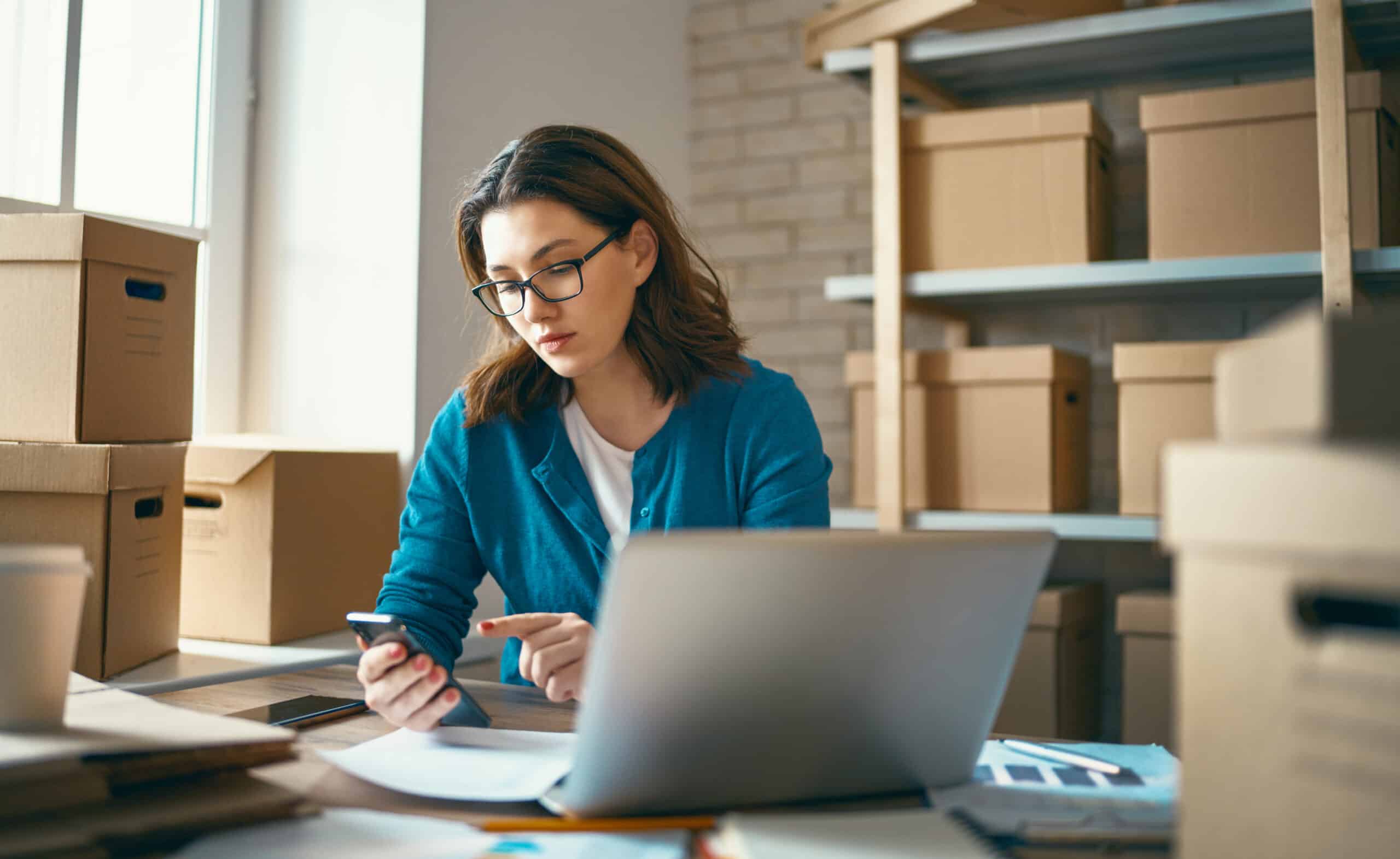 Woman is working at warehouse for online seller. Concept of small web business.