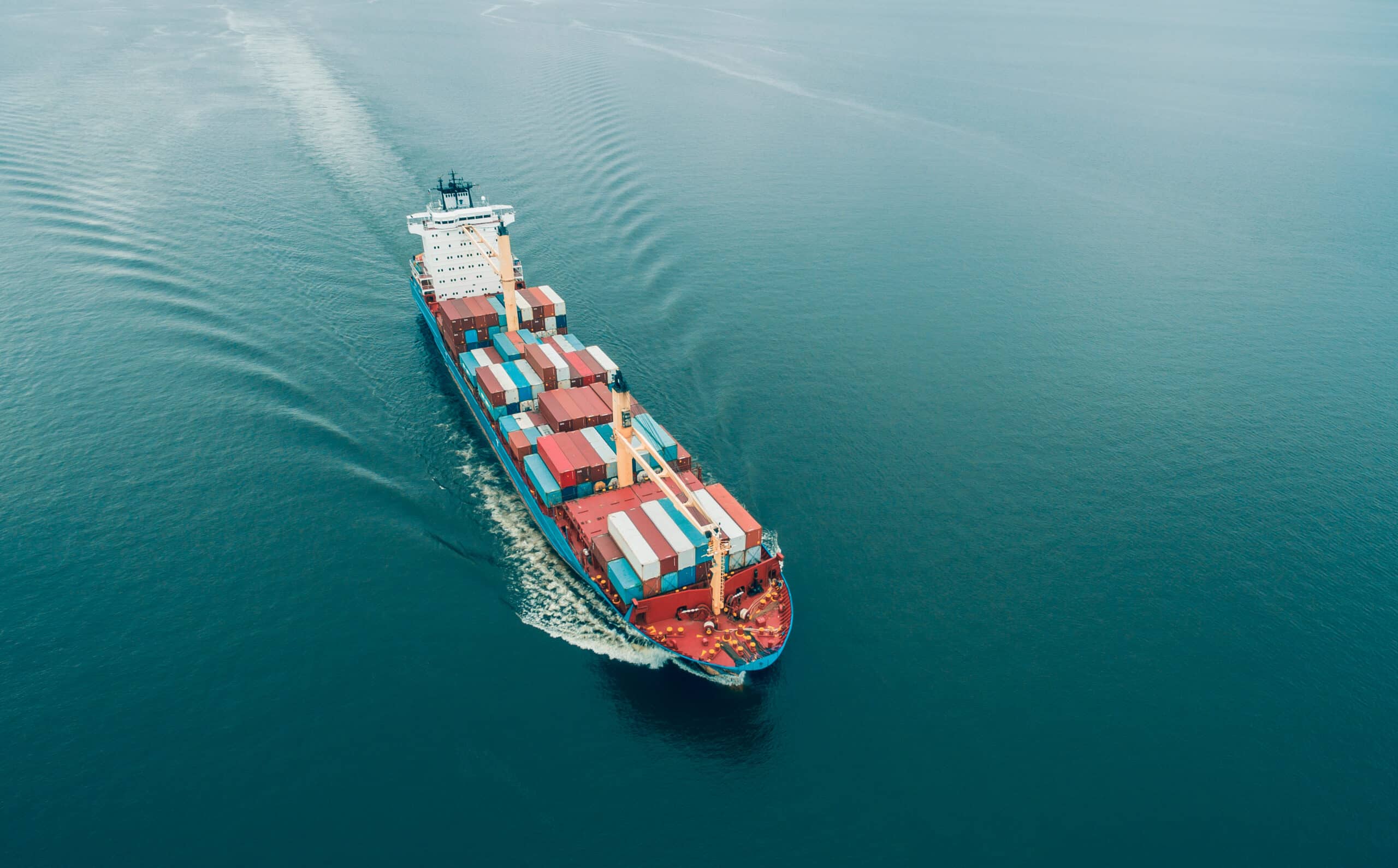 Aerial view of Cargo ship sailing in open sea
