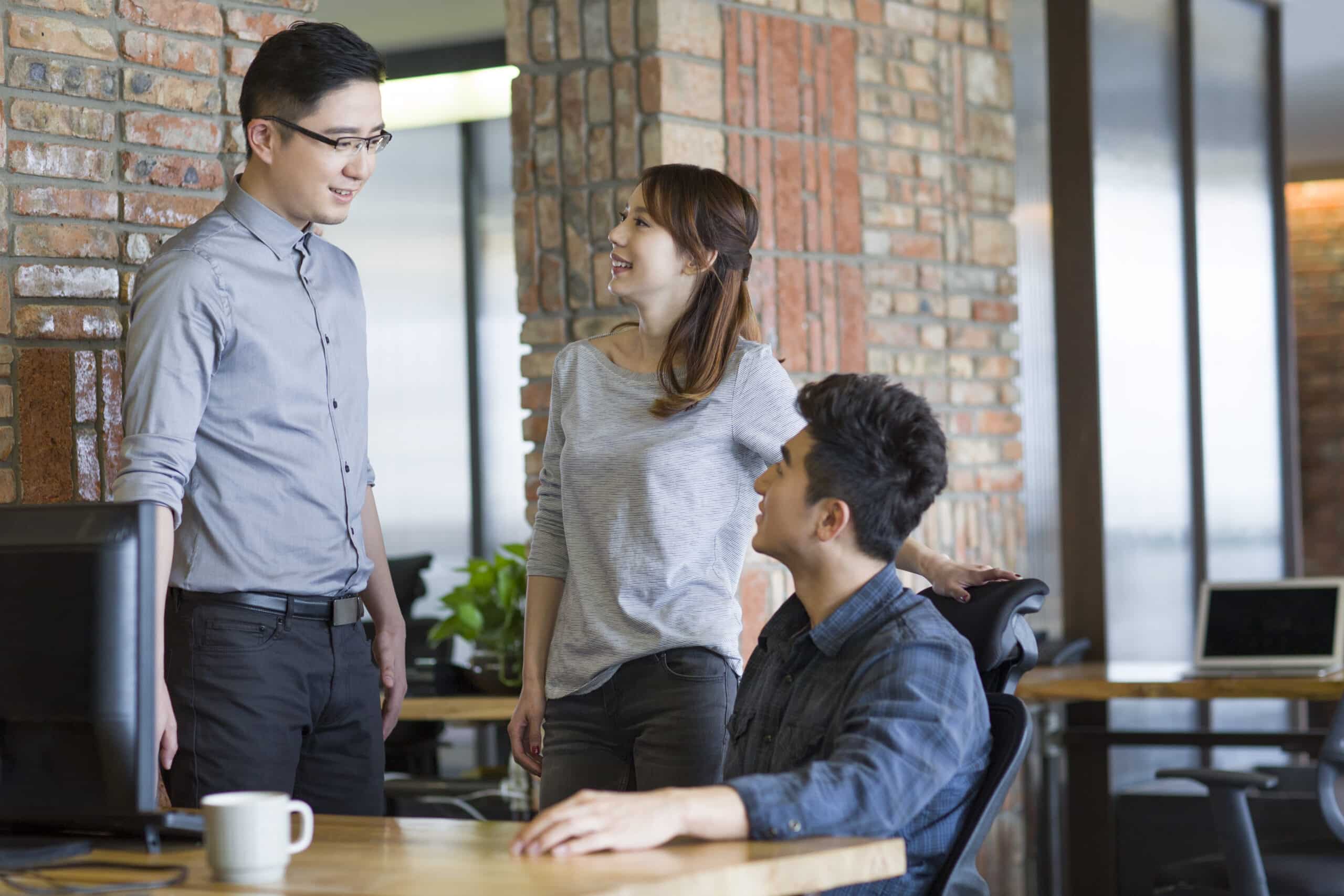 Chinese IT workers talking in office