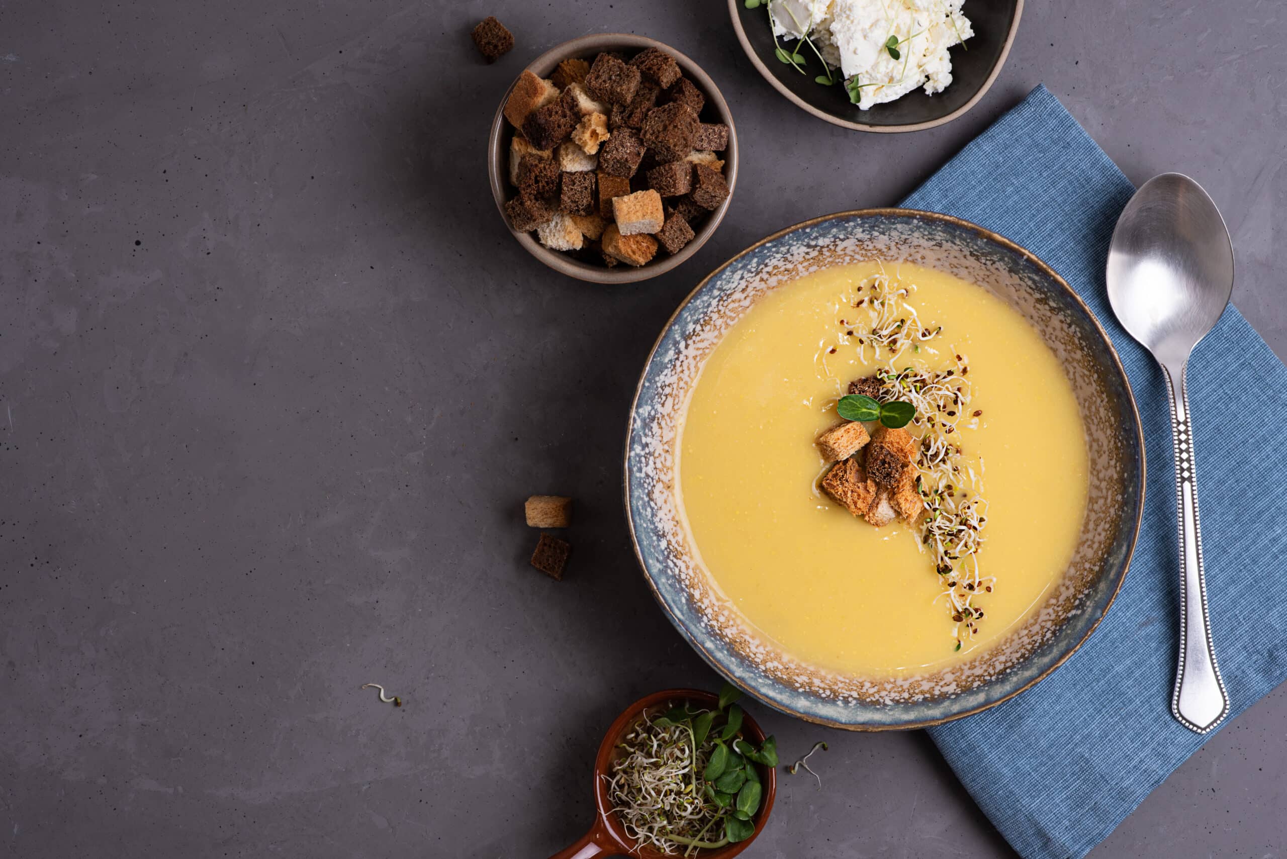 Homemade vegetarian squash cream soup with croutons and microgreens, healthy food concept, copy space.