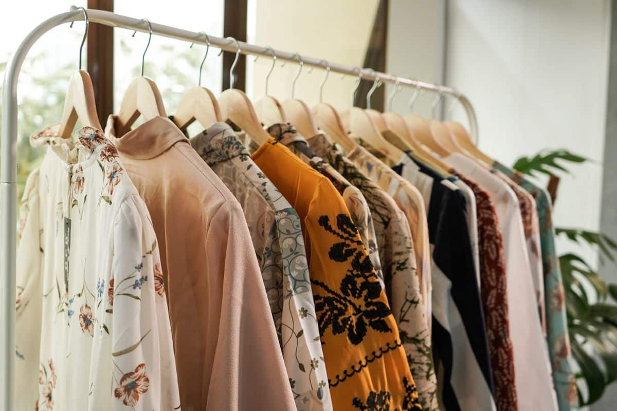 Rows of vibrant, neatly hung shirts representing a variety of styles and sizes, demonstrating the diversity and quality of European clothing manufacturing.