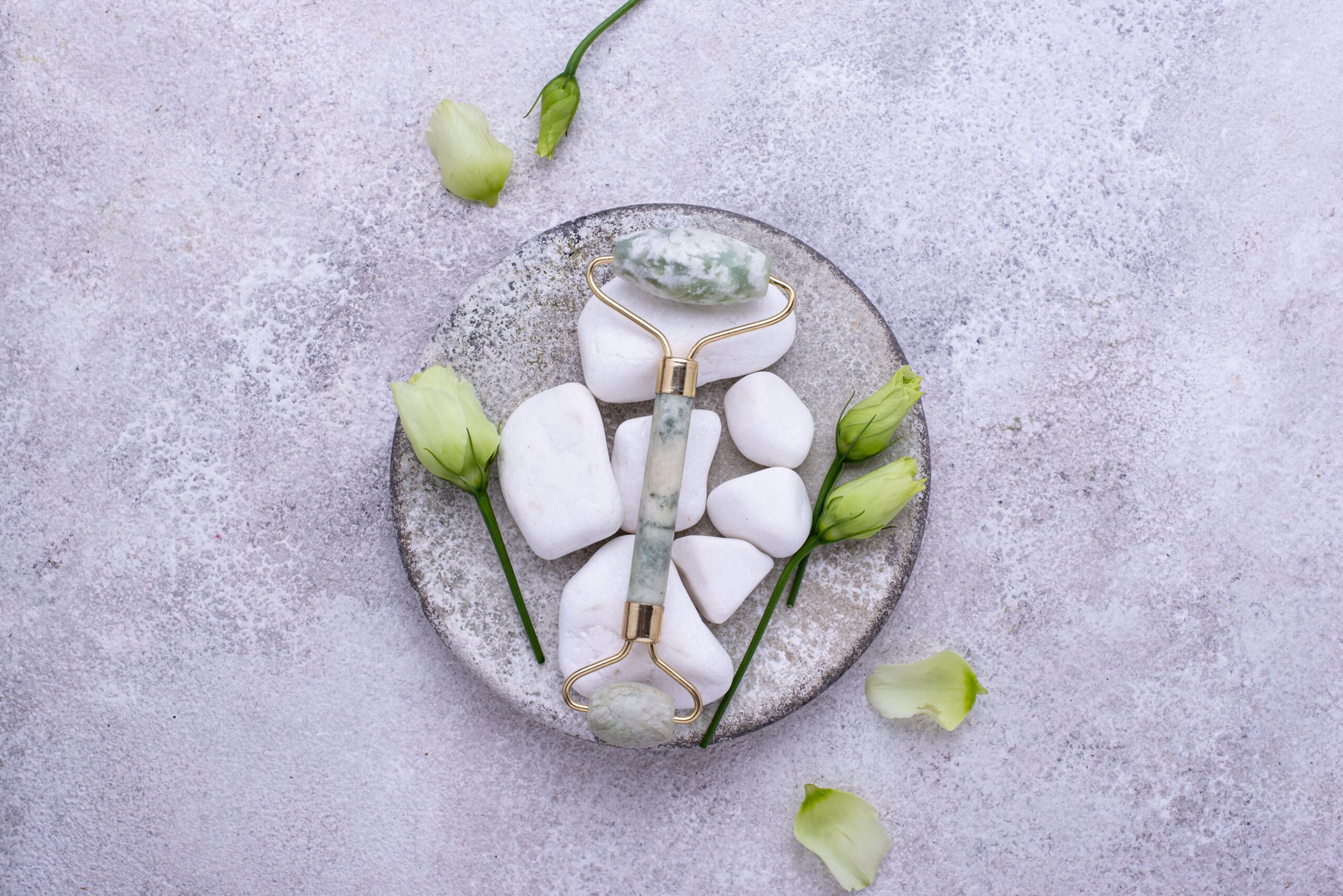 Green jade facial roller for massaging and skincare