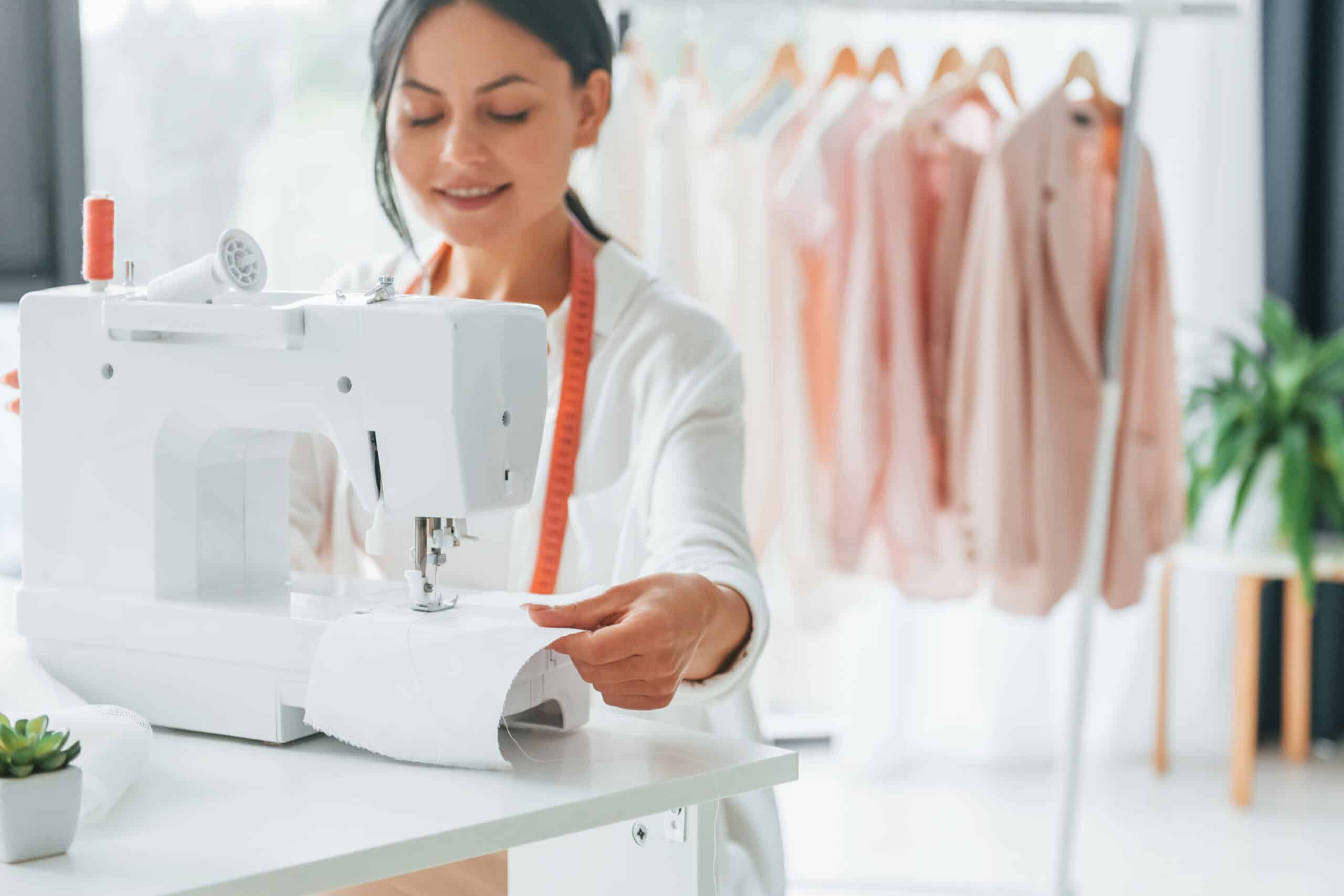 A skilled woman attentively working on a sewing machine, illustrating the precision and craftsmanship involved in European clothing manufacturing.