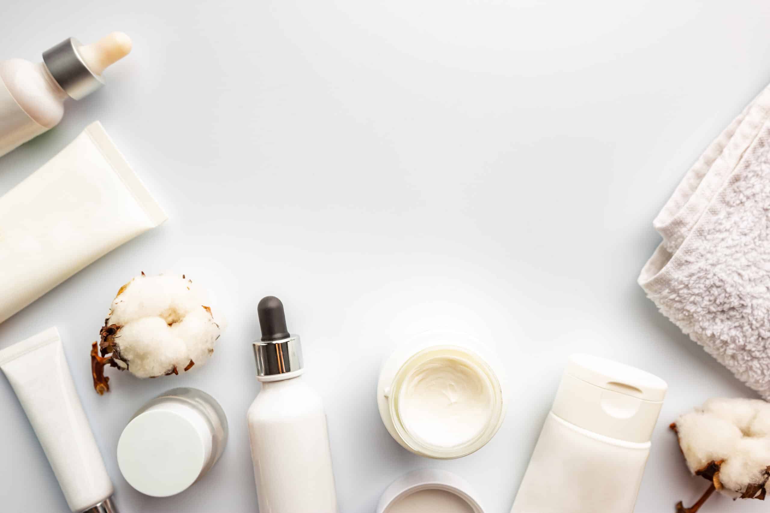 Flat lay composition with skin care products on white background