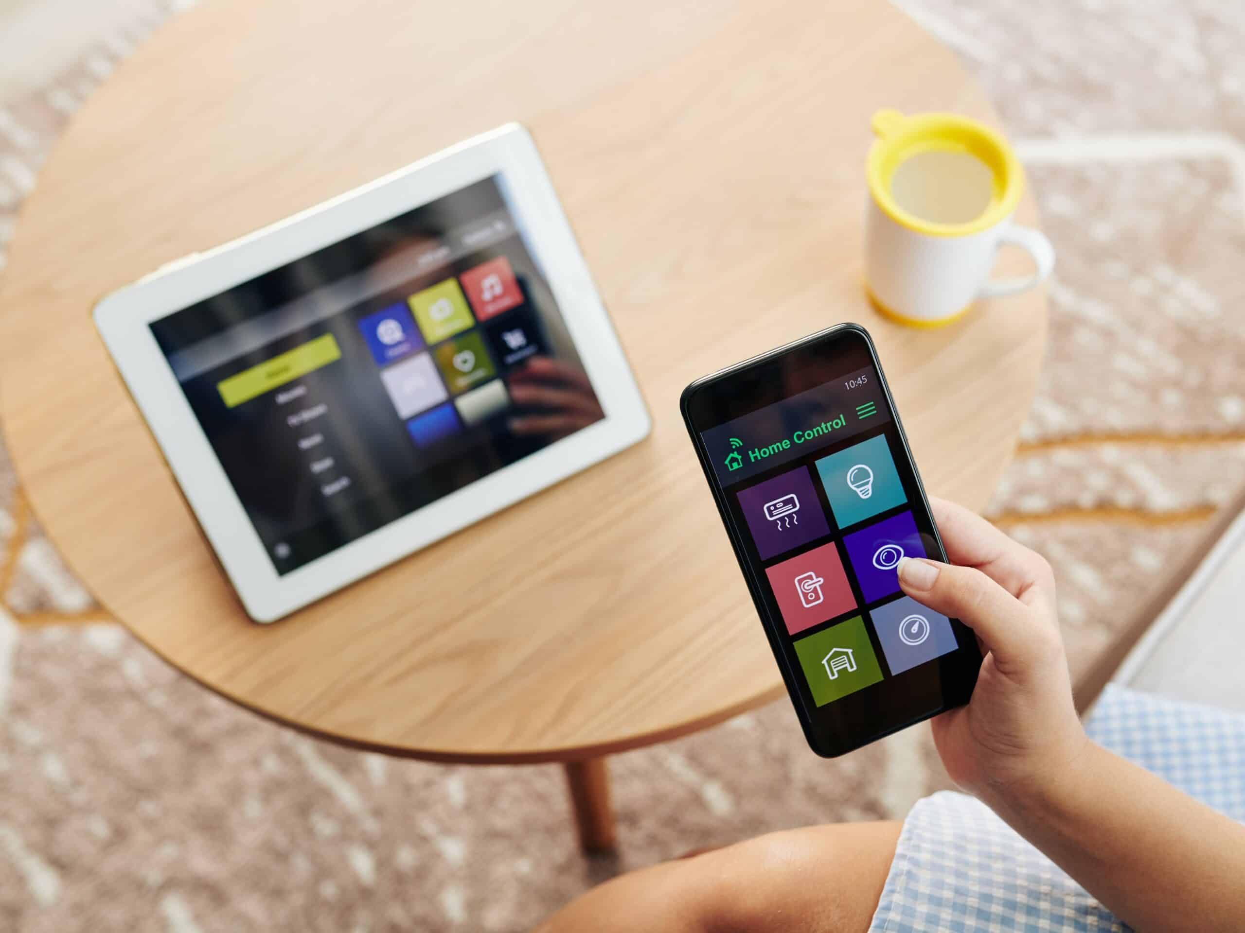 Woman using smart home control application on her smartphone to check cameras or set temperature
