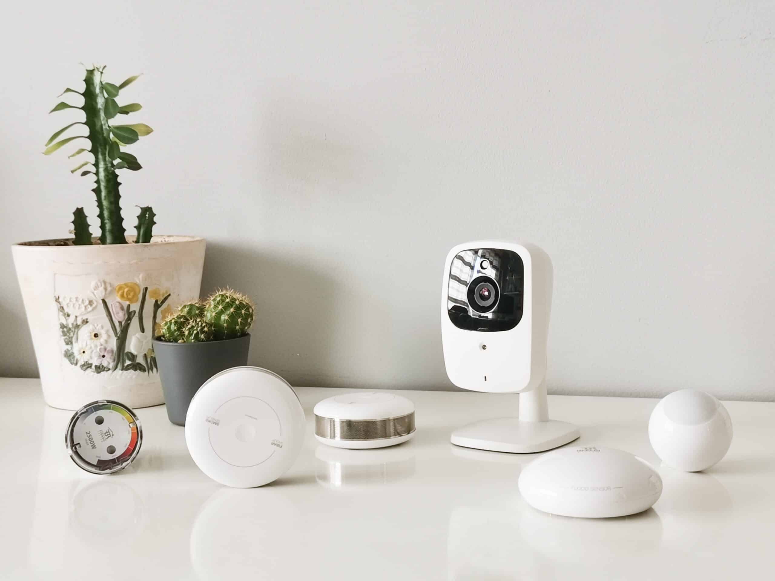 Woman using smart home control application on her smartphone to check cameras or set temperature home design trends 2023