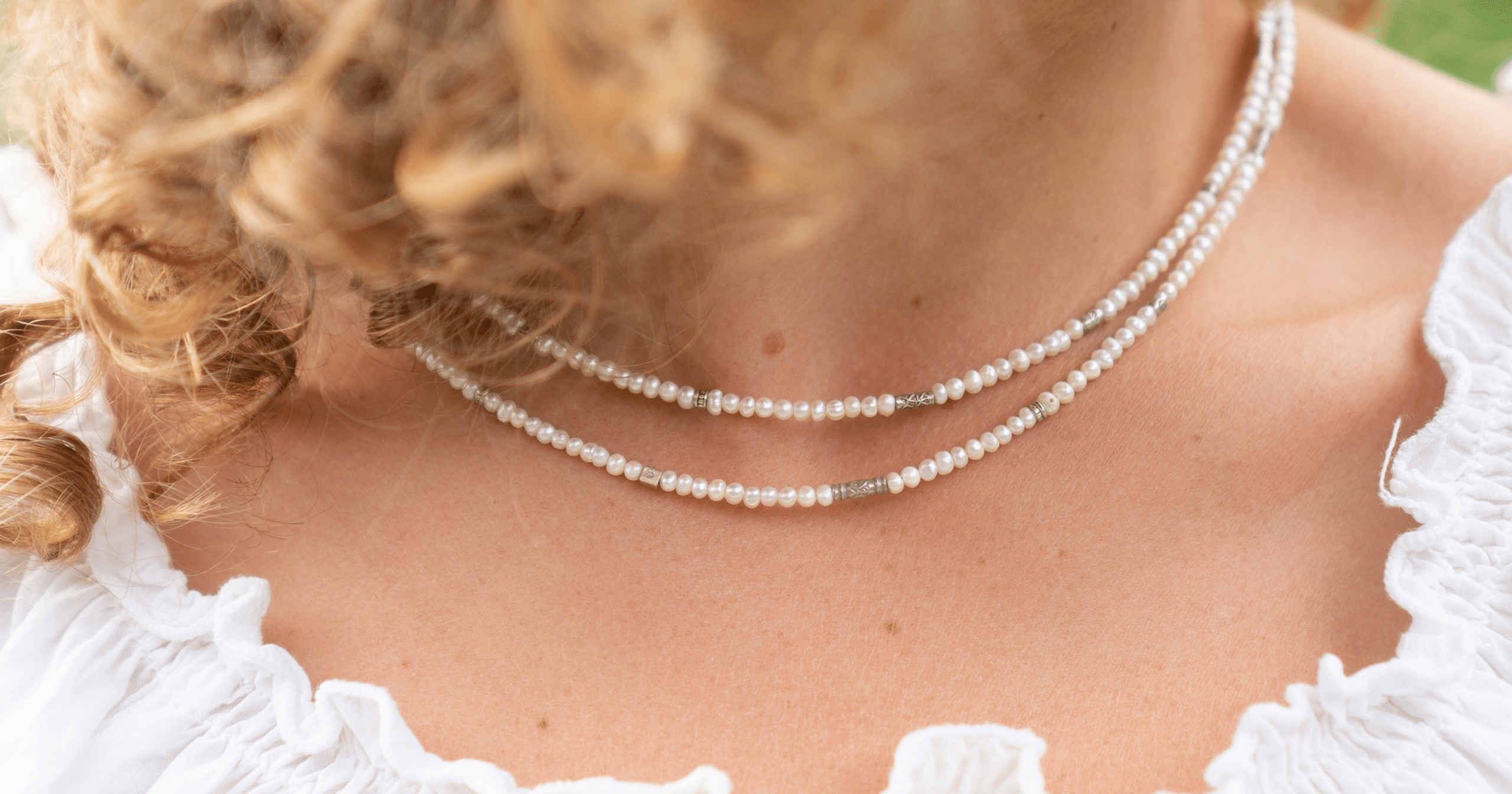Close up of a woman wearing a necklace.