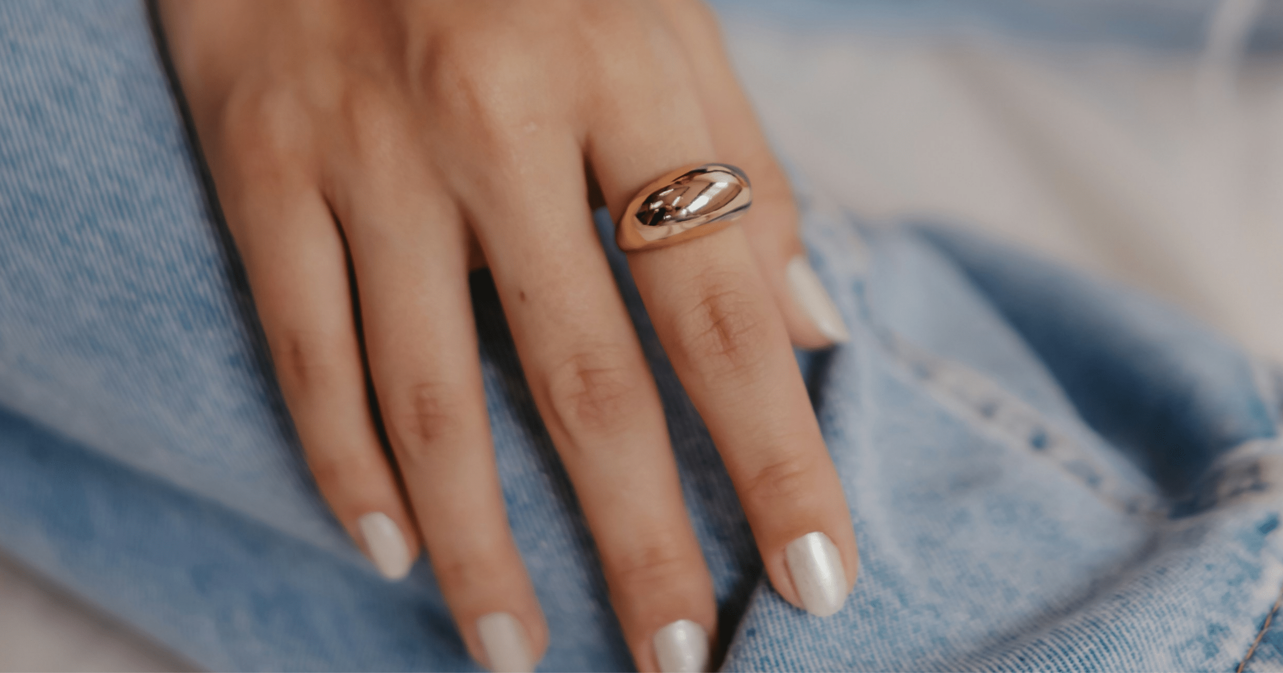 A person modeling a ring on their hand.