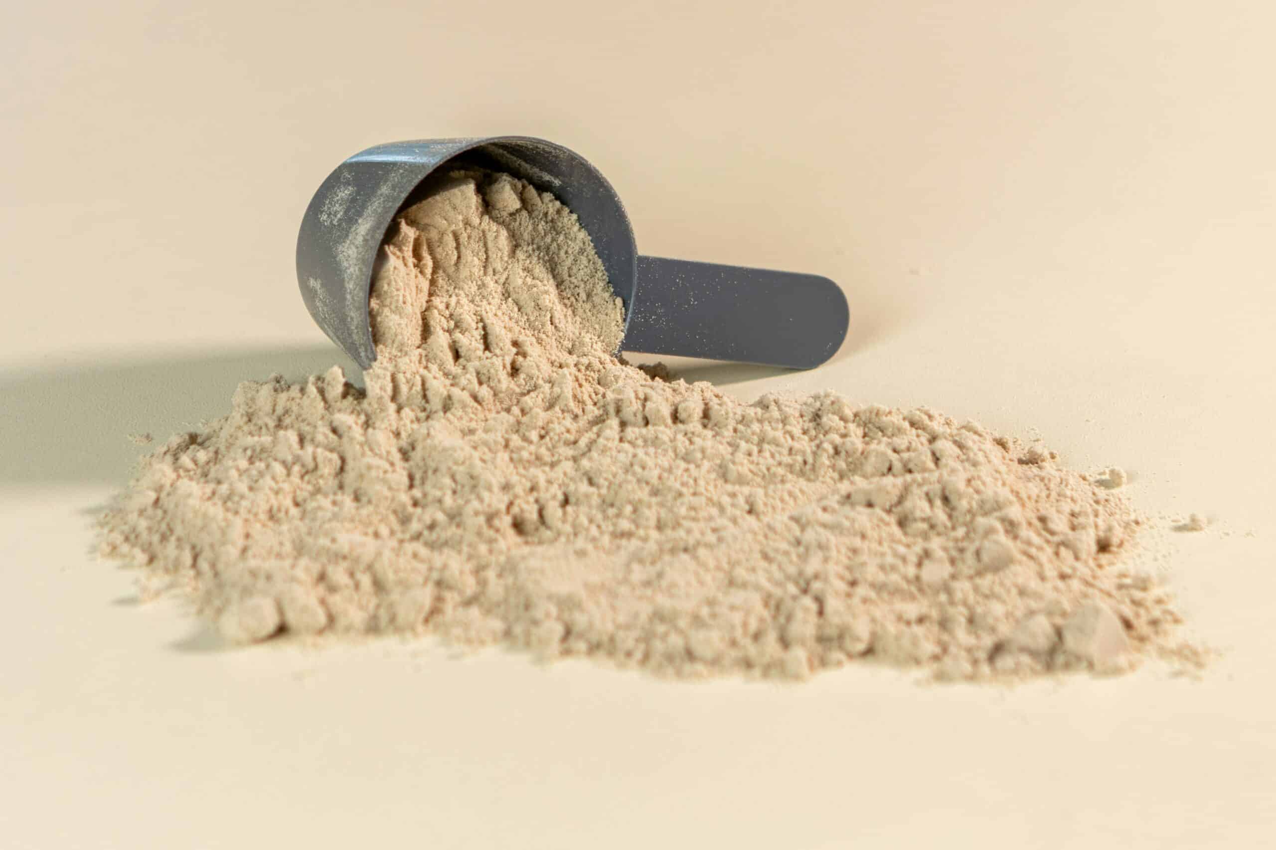 Protein powder knocked over in a measuring cup.