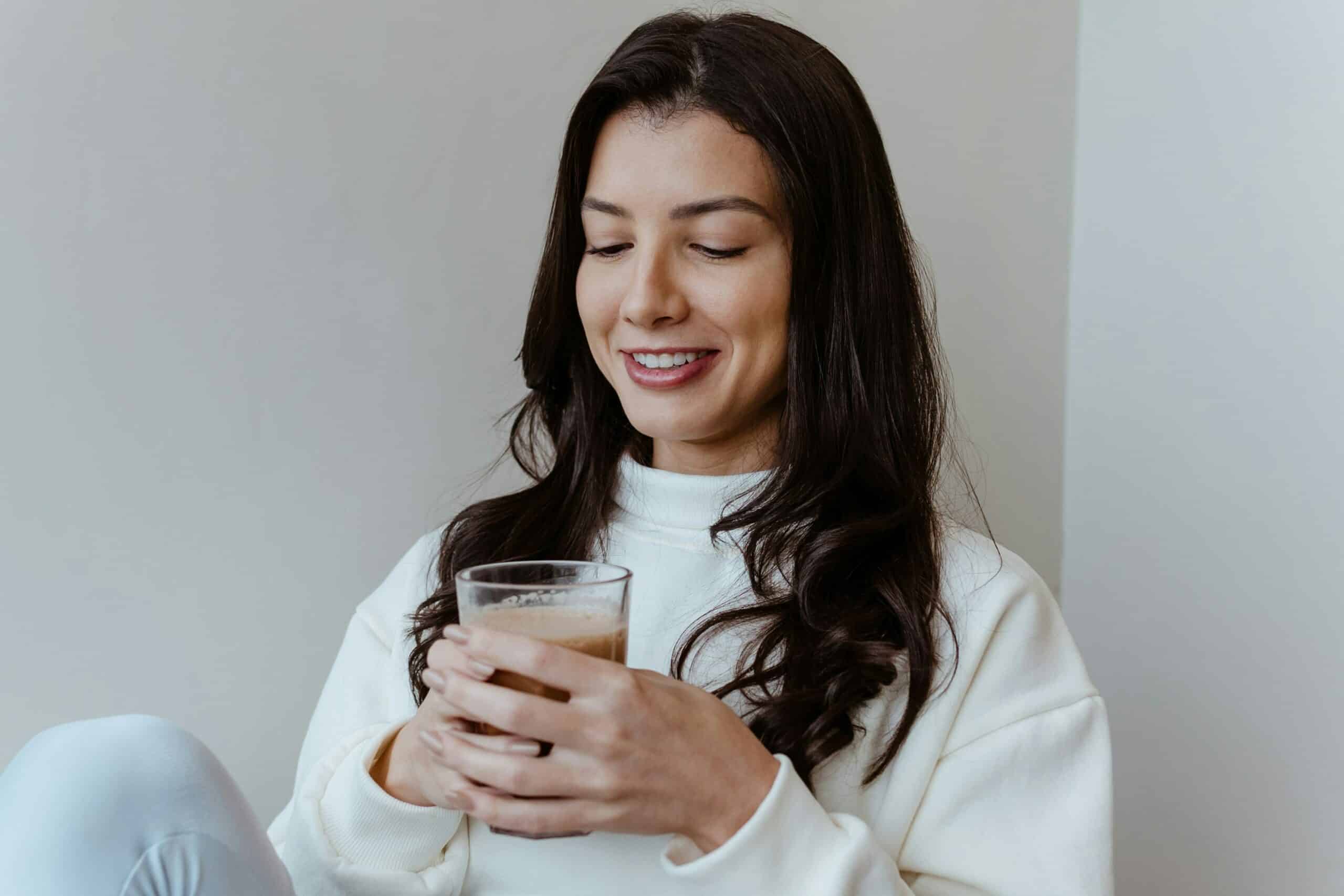 A person holding a supplement beverage.