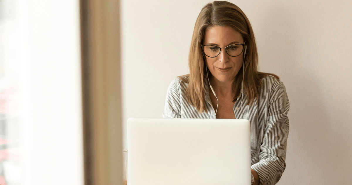 A woman sitting at a computer browsing promotional products and alternatives.