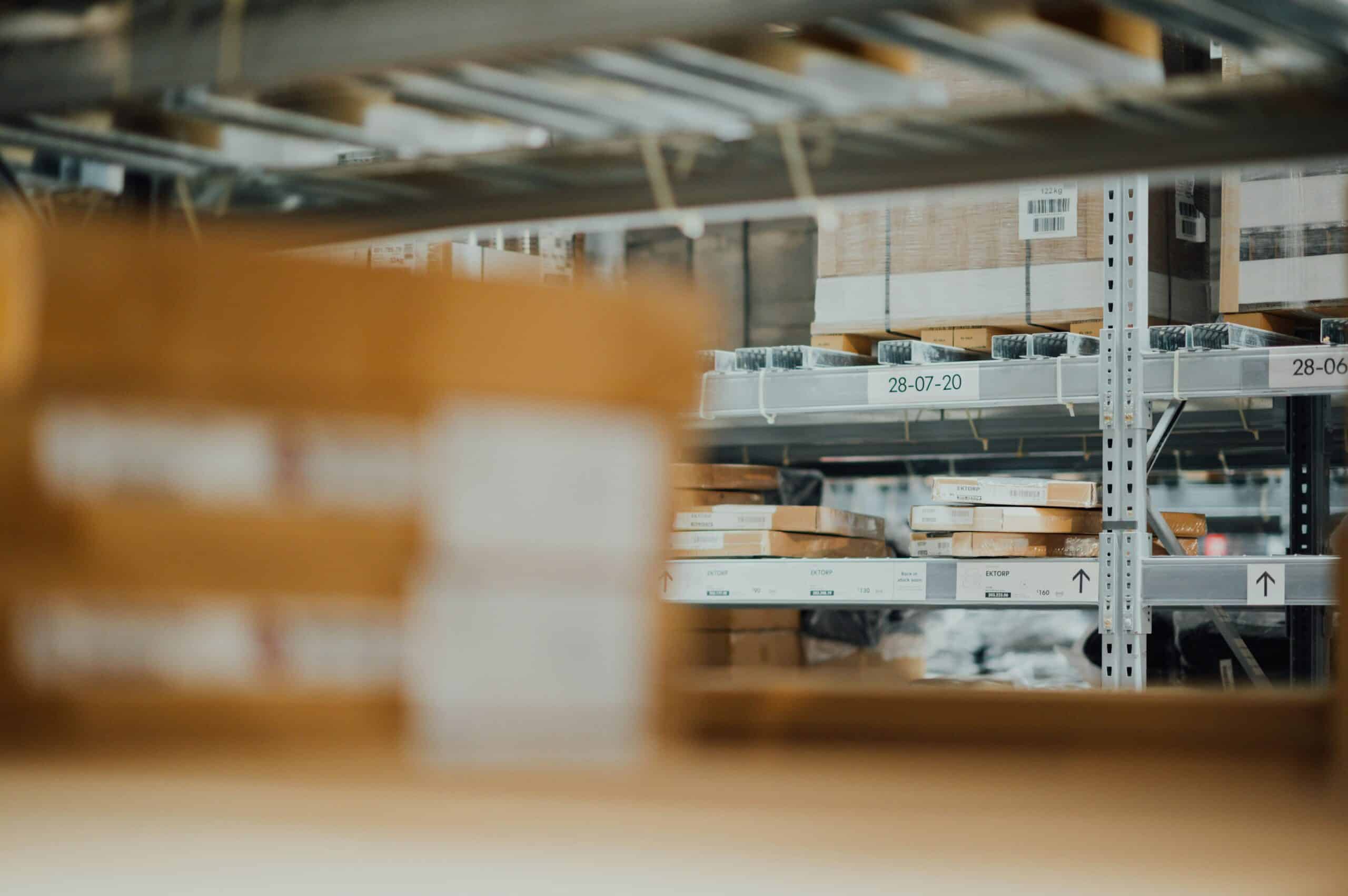 A warehouse full of wholesale bulk products on metal shelfs.