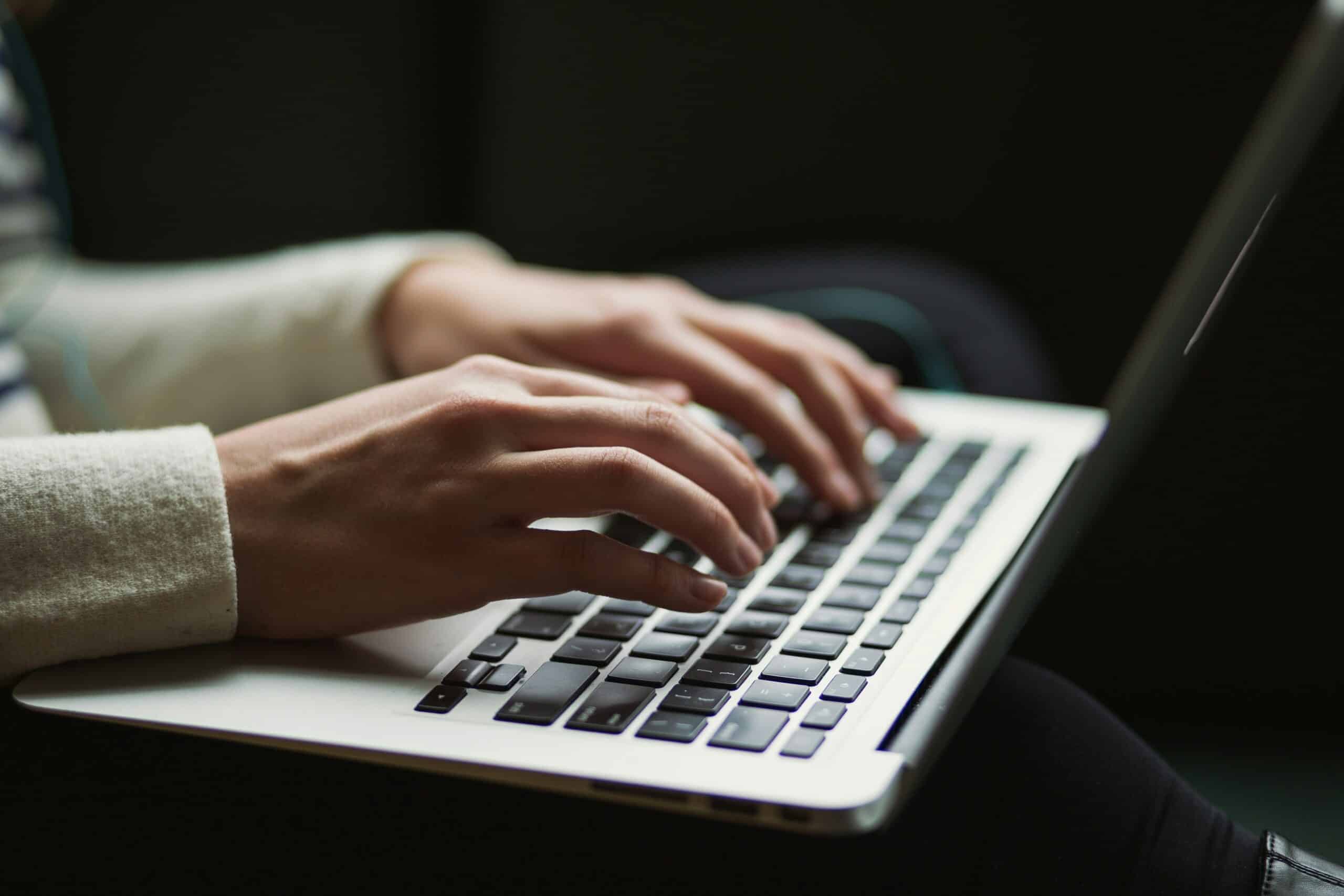 A person typing on their computer.