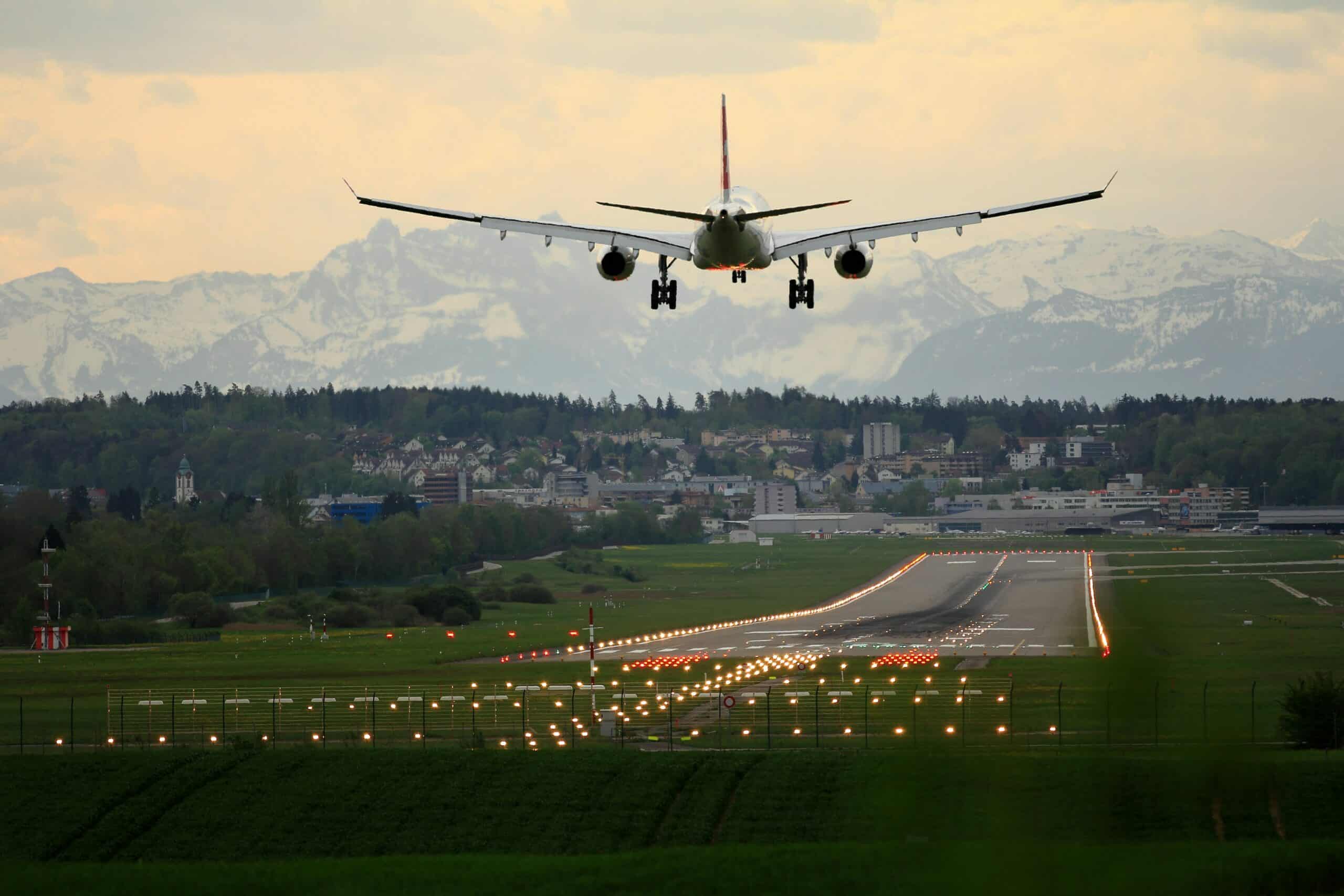 A plane flying into an airport.